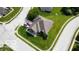 Aerial view of a single-story home showcasing a well-manicured lawn, professional landscaping, and a spacious driveway at 121 George Ct, Danville, IN 46122