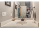 Bathroom showcasing a white vanity with a mirror reflecting a door and a modern shower curtain at 121 George Ct, Danville, IN 46122