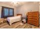 Bedroom featuring a bed, dresser, wood-look floors, and a window with gray curtains at 121 George Ct, Danville, IN 46122