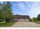 Three car garage and exterior brick on a well manicured lot at 121 George Ct, Danville, IN 46122