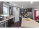 The well-lit kitchen has stainless appliances, a large island, and hardwood floors at 121 George Ct, Danville, IN 46122