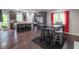This open kitchen features a large island, stainless steel appliances, dark cabinets, and a breakfast table near the window at 121 George Ct, Danville, IN 46122