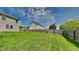 Spacious backyard with lush green grass and a wooden fence, ideal for outdoor activities at 1305 Gleneagle Dr, Indianapolis, IN 46239