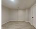 Clean, unfinished basement featuring light vinyl floors, neutral walls, and a blank canvas for customization at 1305 Gleneagle Dr, Indianapolis, IN 46239