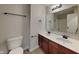 Modern bathroom with double sinks, wood cabinets, sleek fixtures, and neutral decor at 1305 Gleneagle Dr, Indianapolis, IN 46239