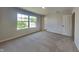 This bedroom features neutral carpet, light gray walls, and a large window, offering a serene space at 1305 Gleneagle Dr, Indianapolis, IN 46239