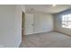 Bright bedroom with neutral carpet, gray walls, and a large window providing ample natural light at 1305 Gleneagle Dr, Indianapolis, IN 46239