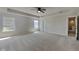 Large bedroom featuring soft neutral carpet, a ceiling fan, and a spacious closet at 1305 Gleneagle Dr, Indianapolis, IN 46239