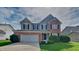 Charming two-story home with brick accents, well-kept landscaping, and a two-car garage at 1305 Gleneagle Dr, Indianapolis, IN 46239