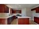 Modern kitchen with white countertops, stainless steel appliances, and dark wood cabinetry at 1305 Gleneagle Dr, Indianapolis, IN 46239