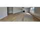 Spacious living room with wood-look flooring, fireplace, ceiling fan, and lots of natural light at 1305 Gleneagle Dr, Indianapolis, IN 46239