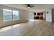 Open-concept living room with slider door, wood-look floors, and adjacent kitchen area at 1305 Gleneagle Dr, Indianapolis, IN 46239