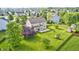 Aerial view of a spacious backyard with lush greenery, a patio, and mature trees providing shade at 1306 Flat Wood Ct, Brownsburg, IN 46112