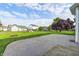 Large backyard with a spacious concrete patio, mature tree, and well-maintained lawn at 1306 Flat Wood Ct, Brownsburg, IN 46112