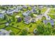Aerial view of a large, green backyard with a basketball hoop, patio, mature trees, and shed at 1306 Flat Wood Ct, Brownsburg, IN 46112