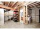 Unfinished basement showcasing utility setup, shelving, and bathroom rough-in plumbing ready for future development at 1306 Flat Wood Ct, Brownsburg, IN 46112