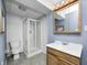 Cozy bathroom featuring a glass-enclosed shower and wooden vanity with a framed mirror cabinet at 1306 Flat Wood Ct, Brownsburg, IN 46112