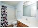 Light blue bathroom featuring a shower-tub combo with patterned shower curtain, toilet, and sink with vanity at 1306 Flat Wood Ct, Brownsburg, IN 46112