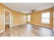 Bedroom with warm yellow walls, ceiling fan, wood-look flooring, and ensuite bathroom at 1306 Flat Wood Ct, Brownsburg, IN 46112