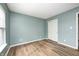 Bedroom with wood-look floors, neutral walls, and sliding door closet at 1306 Flat Wood Ct, Brownsburg, IN 46112