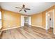 Spacious bedroom boasts wood-look floors and neutral walls, with open door to hallway at 1306 Flat Wood Ct, Brownsburg, IN 46112