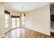 Inviting dining area with hardwood floors, French doors to the backyard, and a hanging pendant light at 1306 Flat Wood Ct, Brownsburg, IN 46112
