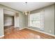 Elegant dining room with hardwood floors, neutral walls, a window with valance, and chandelier at 1306 Flat Wood Ct, Brownsburg, IN 46112