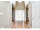 Bright foyer featuring a high ceiling, hardwood floors, and a white front door with sidelights at 1306 Flat Wood Ct, Brownsburg, IN 46112