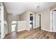 Upstairs hallway with wood floors, window providing natural light, and access to multiple bedrooms at 1306 Flat Wood Ct, Brownsburg, IN 46112
