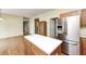 Kitchen island with stainless steel appliances, wood cabinets, hardwood floors and an open design at 1306 Flat Wood Ct, Brownsburg, IN 46112
