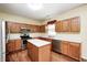 Bright kitchen featuring wood cabinets, stainless steel appliances, hardwood floors and a center island at 1306 Flat Wood Ct, Brownsburg, IN 46112