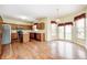 Kitchen and dining area showcasing wood cabinets, stainless steel appliances, and natural light at 1306 Flat Wood Ct, Brownsburg, IN 46112