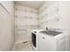 Functional laundry room with washer, dryer, and white wire shelving for ample storage at 1306 Flat Wood Ct, Brownsburg, IN 46112