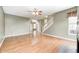 Open living room featuring hardwood floors, stairs, and a view of the foyer with natural light at 1306 Flat Wood Ct, Brownsburg, IN 46112