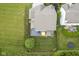 Aerial view showcasing a backyard with a deck, patio, privacy fence, and lush green lawn at 13817 Black Canyon Ct, Fishers, IN 46038