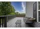 Back deck with outdoor seating and view of fenced backyard and surrounding trees at 13817 Black Canyon Ct, Fishers, IN 46038