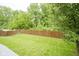 Manicured backyard featuring lush green grass and a privacy fence at 13817 Black Canyon Ct, Fishers, IN 46038