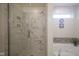Modern bathroom featuring a glass shower door and marble tile, creating a luxurious feel at 13817 Black Canyon Ct, Fishers, IN 46038