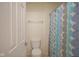 Cozy bathroom with a toilet, towel bar, and a shower with a patterned curtain at 13817 Black Canyon Ct, Fishers, IN 46038