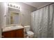 Bathroom featuring a shower with a blue curtain, sink, and a modern toilet at 13817 Black Canyon Ct, Fishers, IN 46038