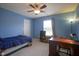 Inviting bedroom featuring a desk, carpeted floors and a ceiling fan, perfect for relaxation or study at 13817 Black Canyon Ct, Fishers, IN 46038