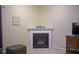 Modern fireplace with decorative mantle, next to tv and ottoman, creating a cozy focal point at 13817 Black Canyon Ct, Fishers, IN 46038