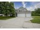 Well-maintained home with a three-car garage, lawn, and beautiful landscaping at 13817 Black Canyon Ct, Fishers, IN 46038