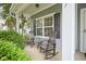 Charming front porch featuring rocking chairs, lush greenery, and stylish exterior details at 13817 Black Canyon Ct, Fishers, IN 46038