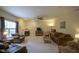 Cozy living room with a fireplace, TV, and ample seating for relaxation and entertainment at 13817 Black Canyon Ct, Fishers, IN 46038