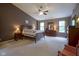 Large main bedroom with carpeting, ceiling fan, and natural light at 13817 Black Canyon Ct, Fishers, IN 46038