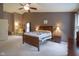 Spacious main bedroom with a ceiling fan and a cozy sitting area at 13817 Black Canyon Ct, Fishers, IN 46038