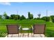 Outdoor patio seating overlooks lush green lawn and landscape at 14350 Ludwell Ct, Fishers, IN 46037