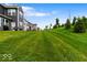 Lush green backyard with well-maintained lawn and view of the home's exterior at 14350 Ludwell Ct, Fishers, IN 46037