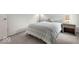 Comfortable bedroom boasts soft carpeting, bedside table with lamp at 14350 Ludwell Ct, Fishers, IN 46037